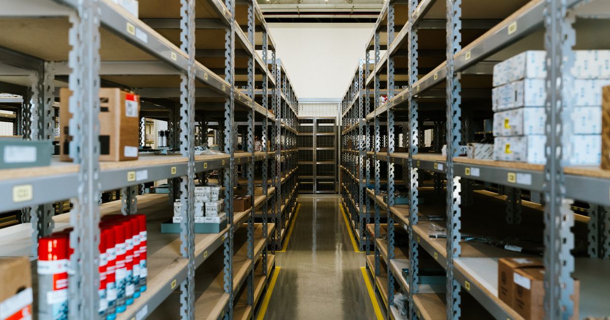 A wide view of an organized industrial warehouse with stocked metal shelving — canadian abrasives supplier, Whitby Abrasives, Ontario, Canada