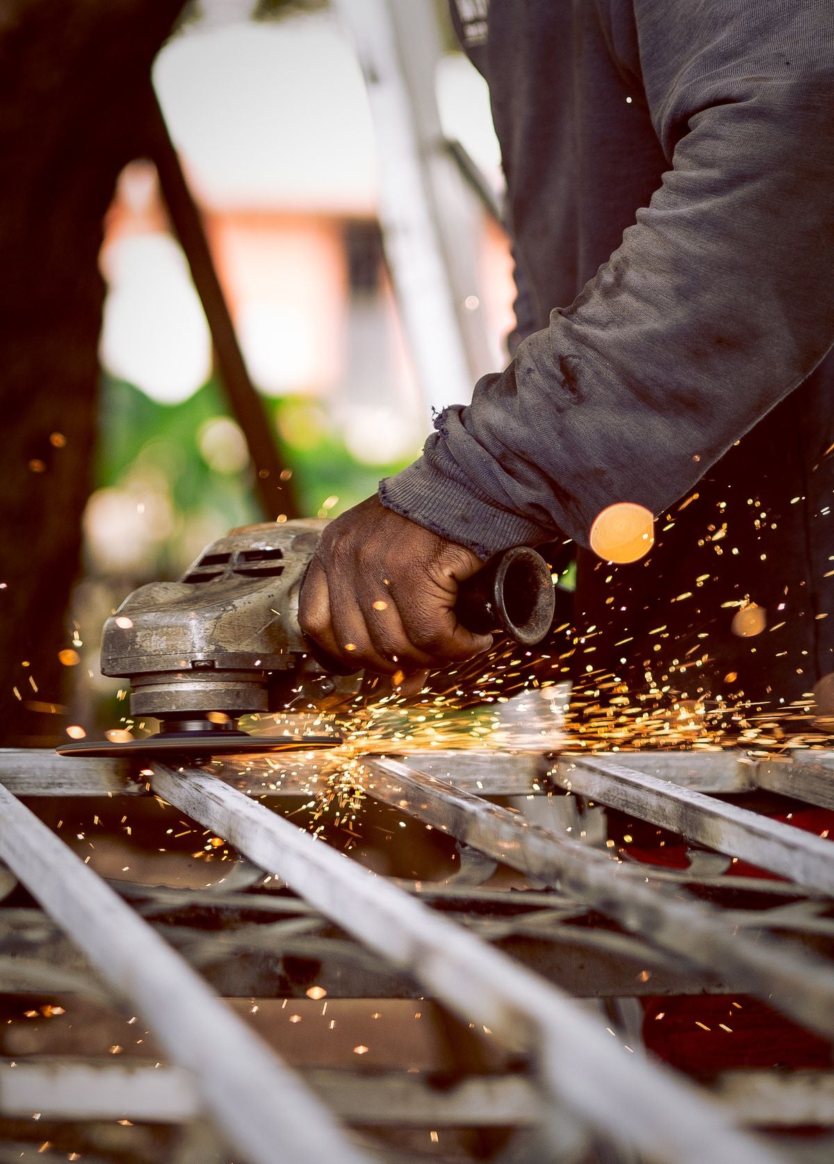 Industrial worker grinding metal with sparks and protective gear — abrasive dust safety, Ontario