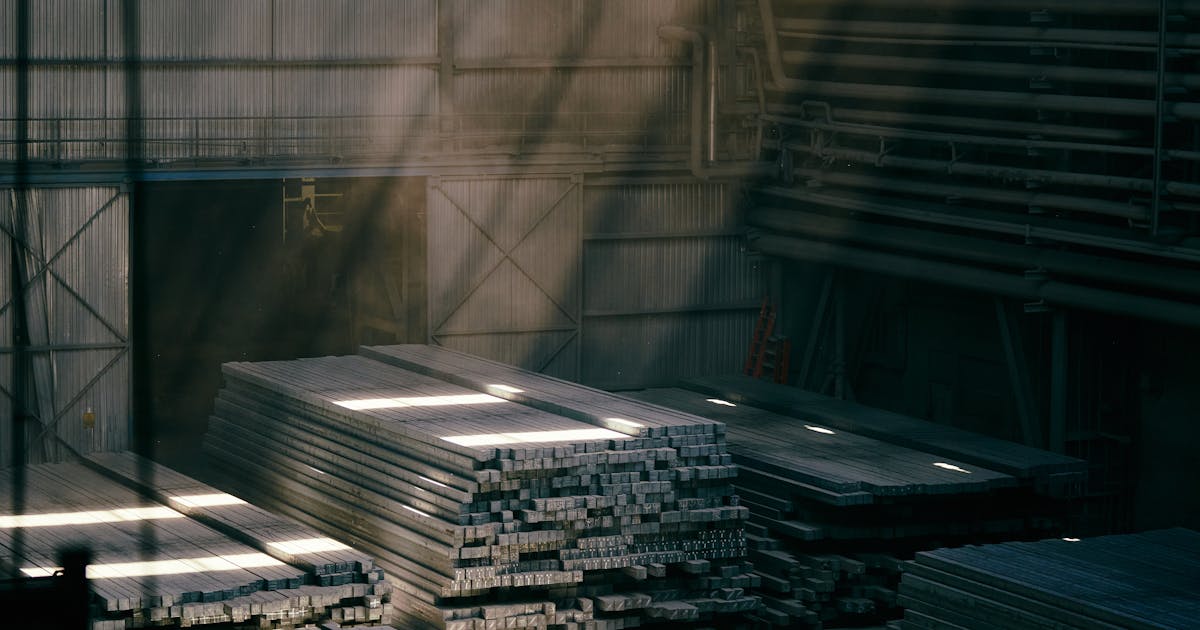 Stacked steel stock in an industrial warehouse — 2026 abrasive pricing and tariffs in Canada