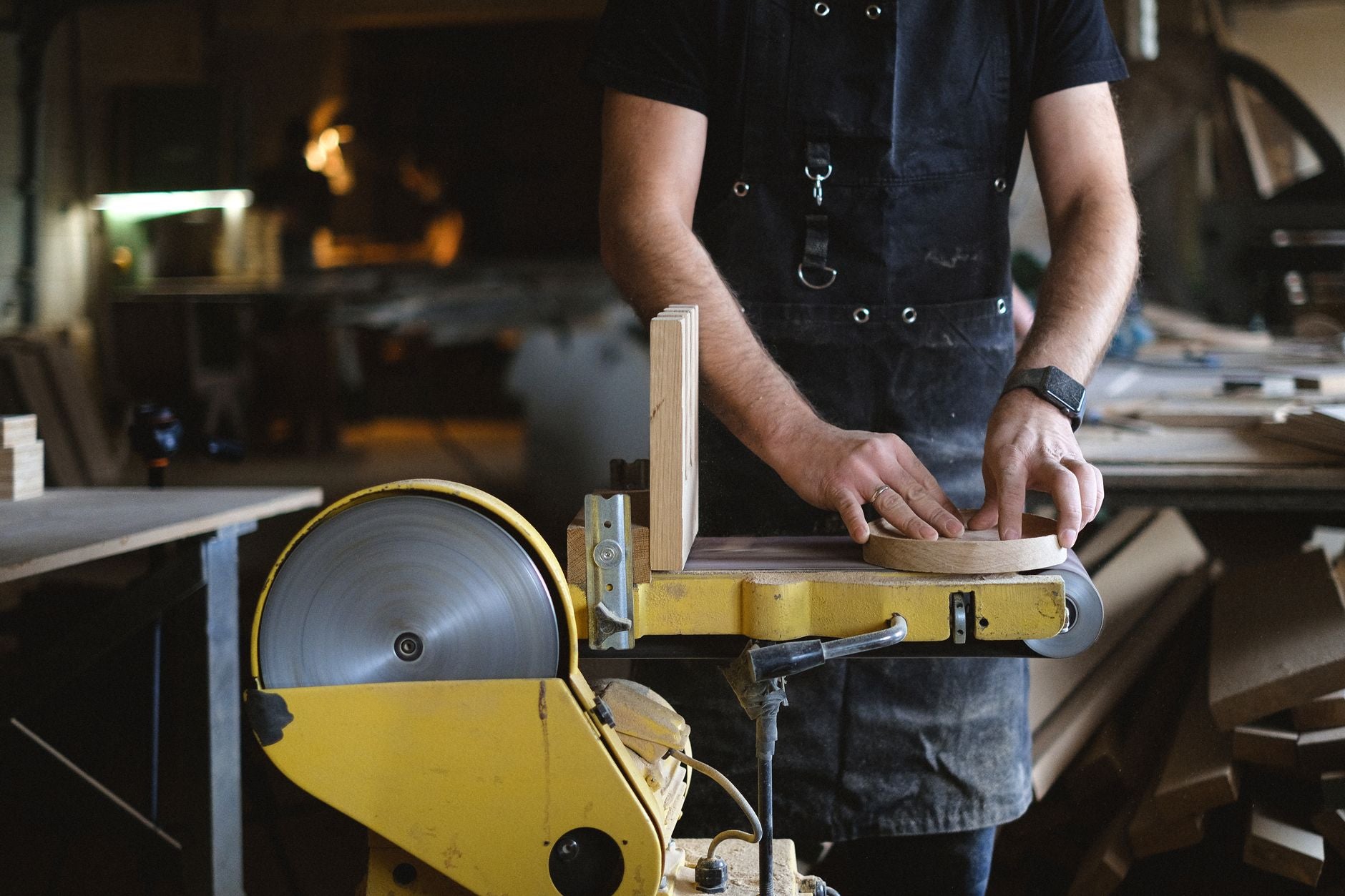 Sanding belt mounted on a belt sander in a workshop