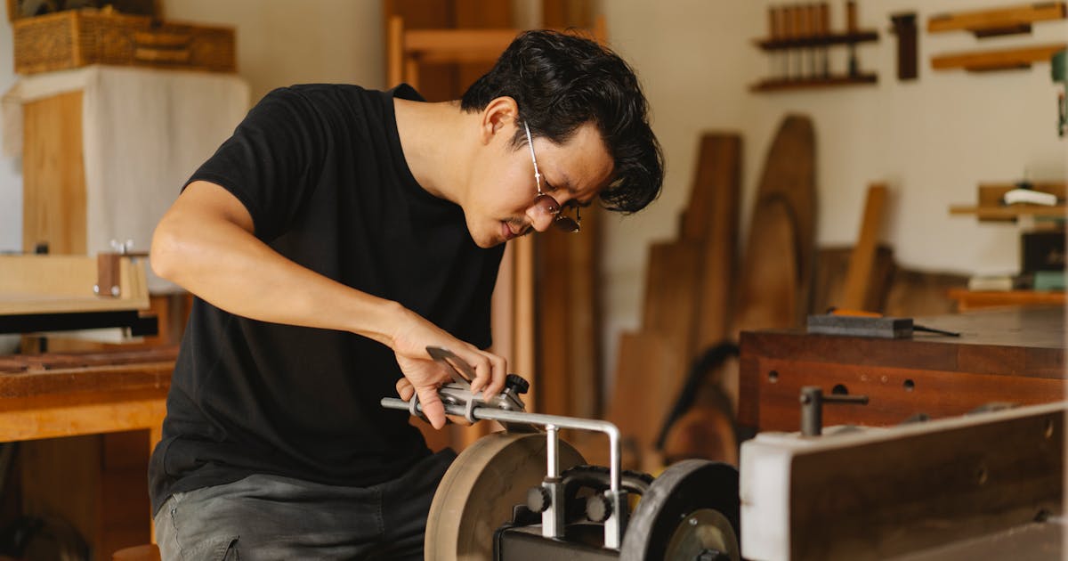 Bench grinding and edge finishing a metal part — Whitby Abrasives deburring wheels, Ontario