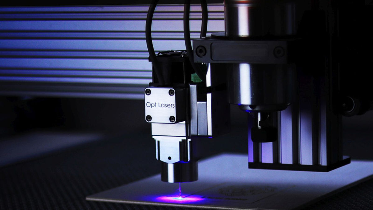 A laser cutting machine cutting a steel sheet in a fabrication shop.