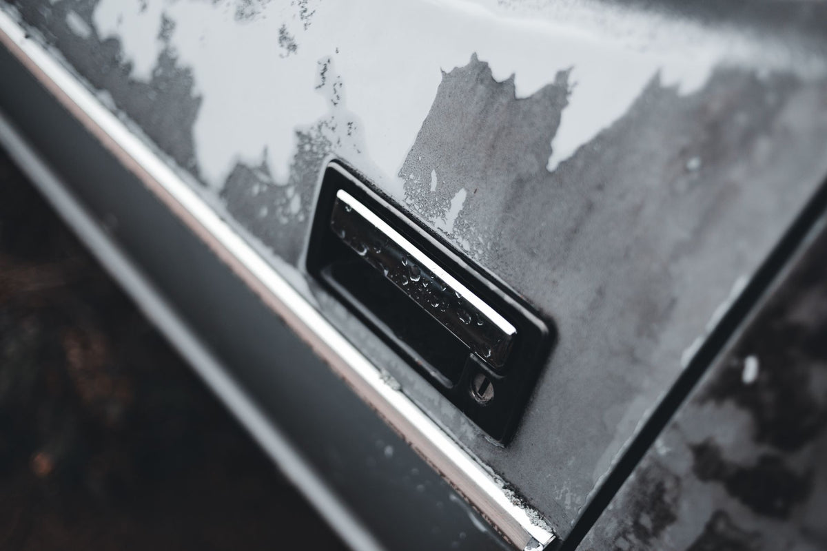 Fine-finishing abrasive disc being used to wet sand automotive clearcoat
