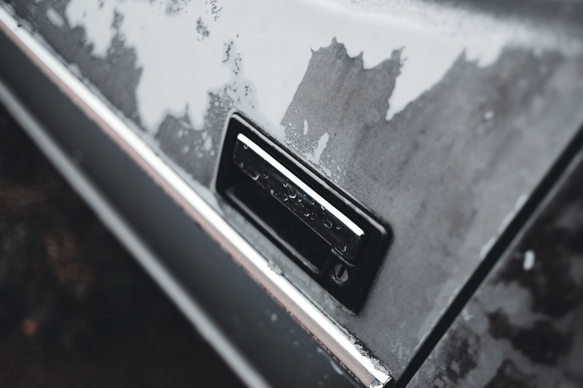Fine-finishing abrasive disc being used to wet sand automotive clearcoat