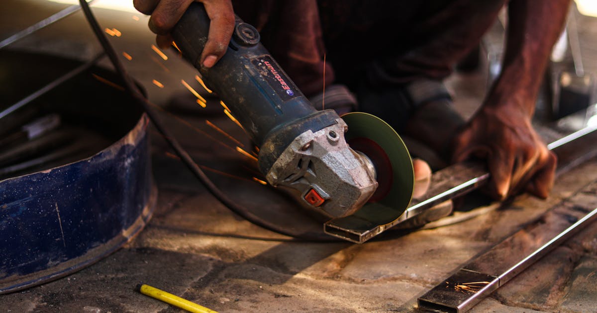 Angle grinder cutting steel with bright sparks — Whitby Abrasives cutting wheels, Ontario