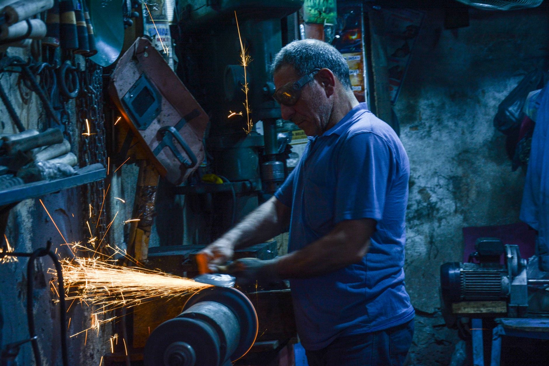 Die grinder with a small mounted point grinding inside a steel workpiece in a fabrication shop