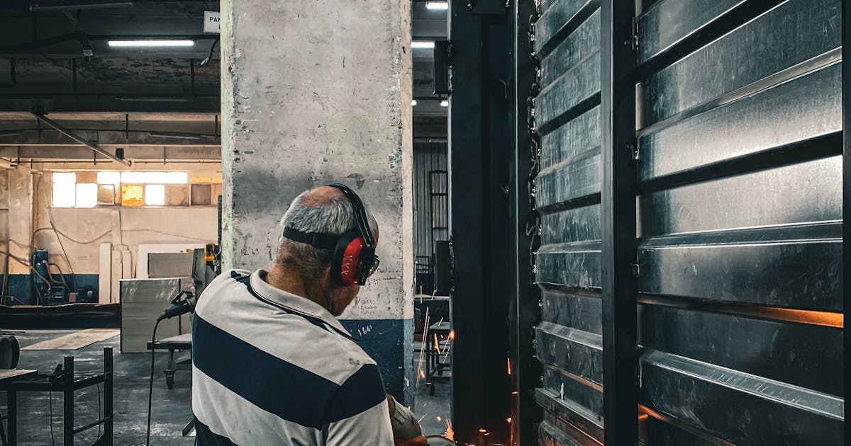 Operator using a disc grinder with sparks — cutting, grinding and finishing abrasives, Ontario