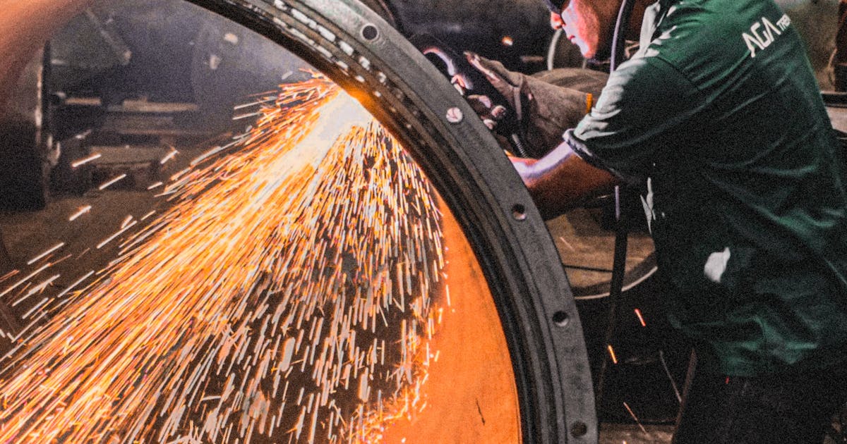 Grinding a welded steel pipe with sparks — pipe and tube abrasives, Ontario