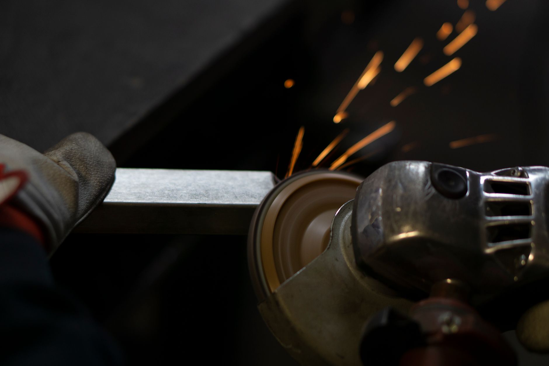 Die grinder with 1/4 inch shank abrasive accessories laid out on a metal fabrication bench
