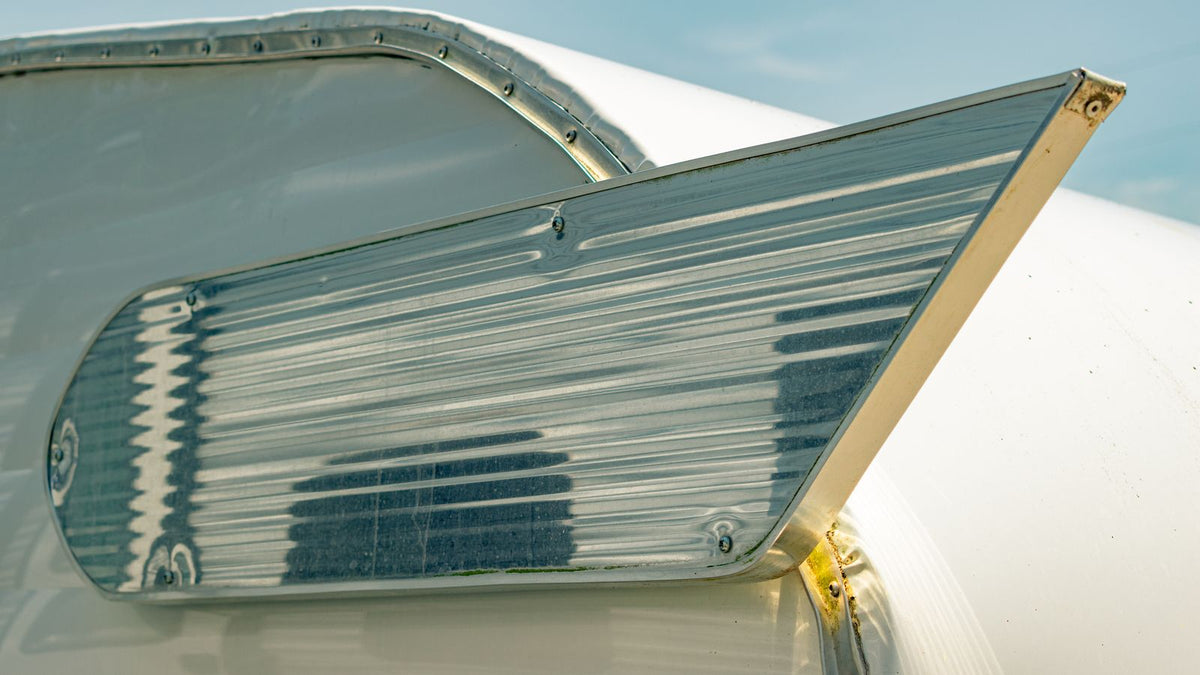 A technician working on an aluminum aircraft structural component in a manufacturing facility.