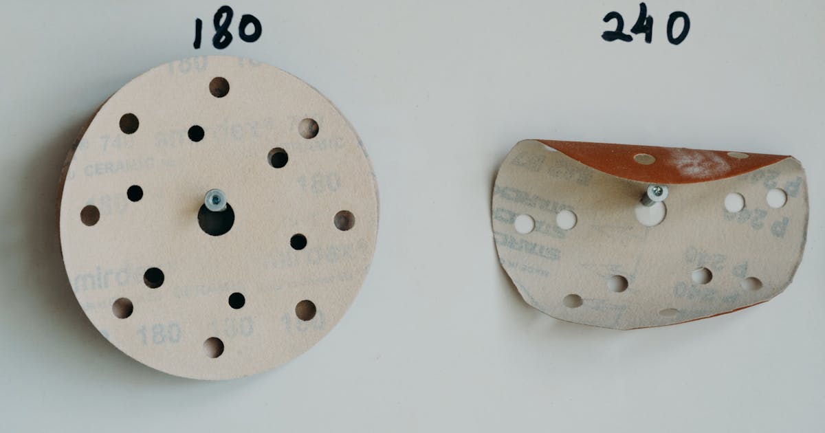 Sanding discs in different grits on a workshop wall — abrasive grit selection guide, Ontario