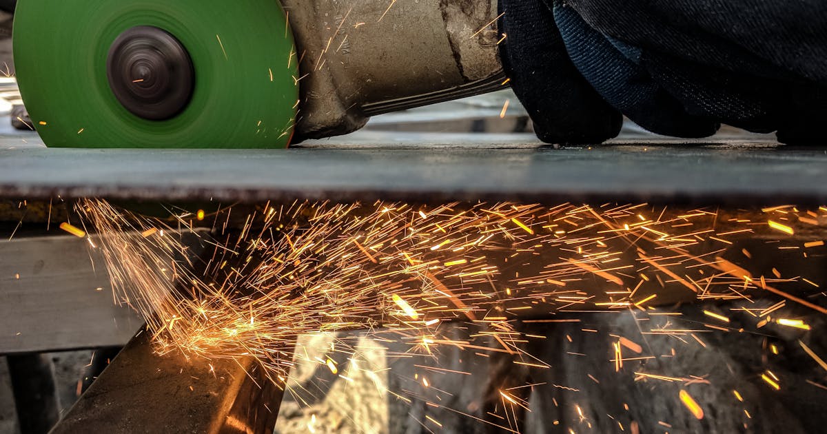 Angle grinder cutting sheet metal in a Canadian fabrication shop