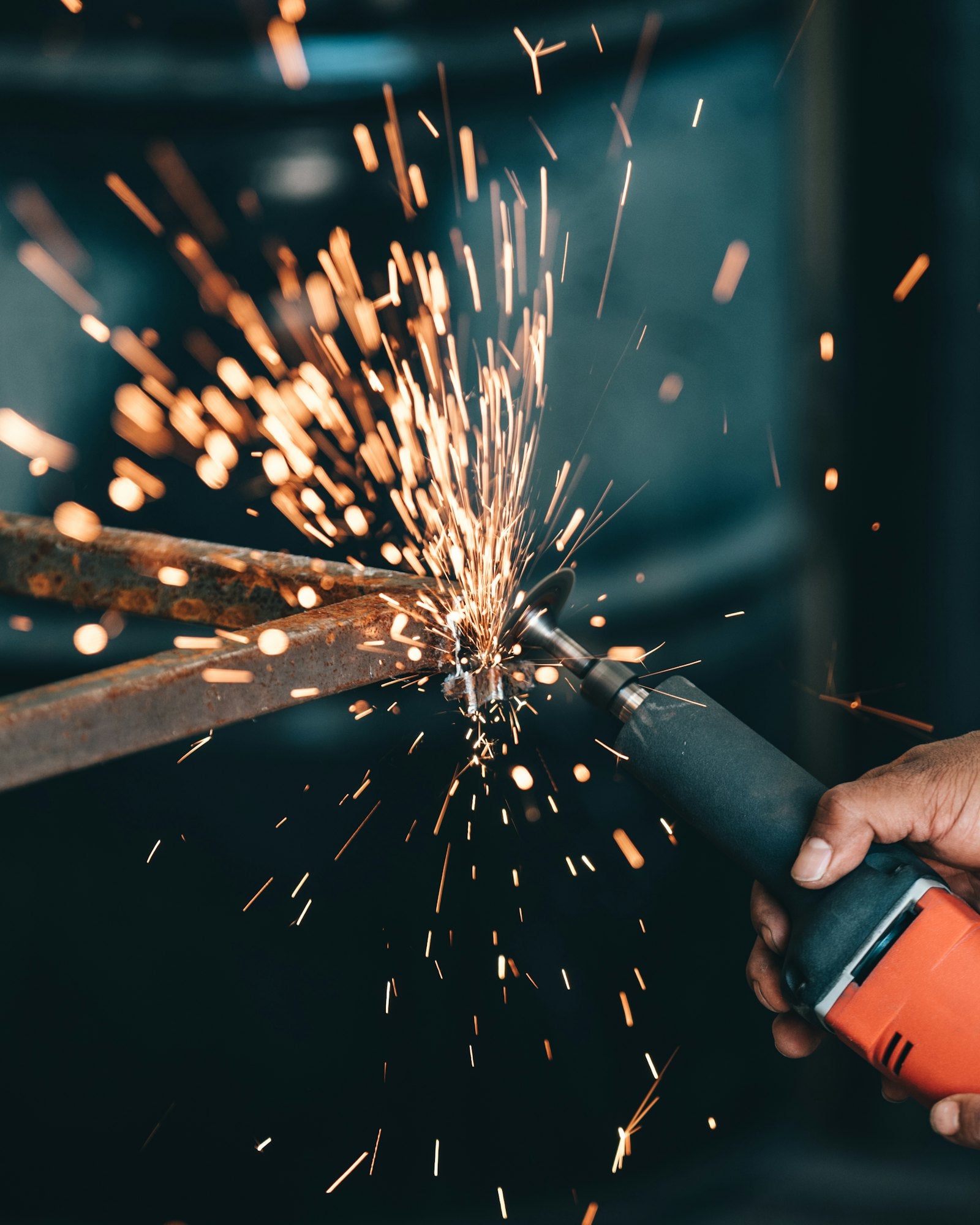 Metalworker using an angle grinder with sparks flying